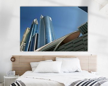 Panorama of long skyscrapers in Dubai skyline against blue sky by Tjeerd Kruse