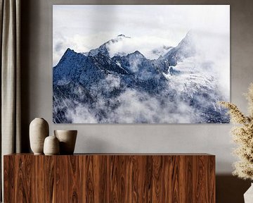 High mountain peaks in the Alps surrounded by clouds by Hidde Hageman