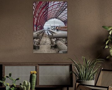 Train track in station hall by Mark Bolijn