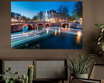 Amsterdam canals with bridge lights and boat light trails by Marcel van den Bos