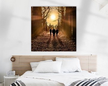 Walkers in the forest with the sun in the backlight by Harrie Muis