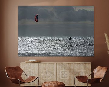 Sporty kitesurfer in the evening sun on the Wadden Sea near the island of Terschelling in the north  by Tonko Oosterink