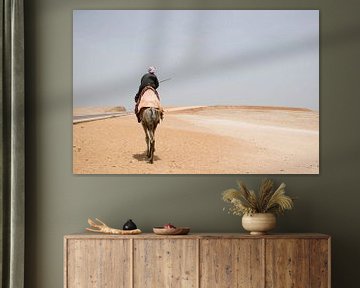 Egyptian man in traditional attire on camel in the desert near Giza. by Marjolein Hameleers