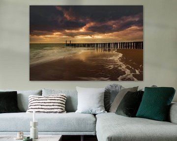 Dutch clouds and typical breakwater of wooden poles along the coast of Zeeland by gaps photography