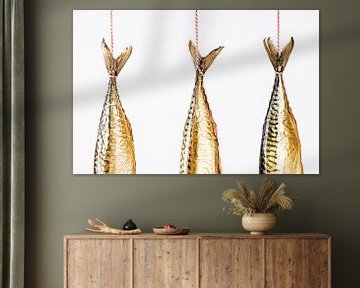 Mackerel tails hanging against a white background by MICHEL WETTSTEIN