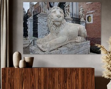 Ancient Roman statue of lion in front of the arsenal in Venice, Italy by Joost Adriaanse