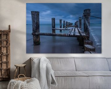 Verweerde houten steiger op het strand in Zingst van Christian Müringer