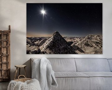 Mountain peaks in the moonlight under a starry sky