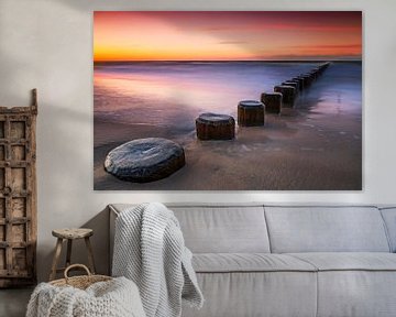 Groynes by the sea at sunset