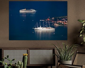 Beautiful cruise ships (one sailing) are far below among the dark blue near the town with red roofs, by Michael Semenov