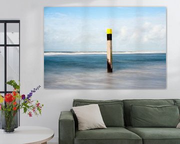 Wooden pole at the beach by Hans Kwaspen