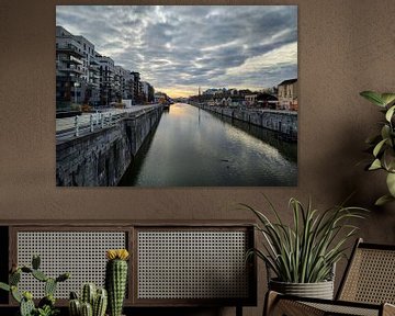 View of canal in Brussels, Belgium with sunrise on the horizon by Deborah Blanc