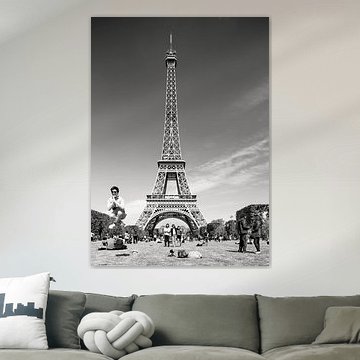 Jumping man at Eiffel Tower in Paris in black and white