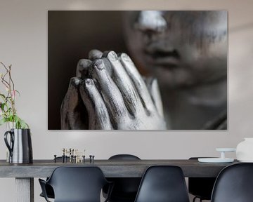 Namasté. Close-up of the hands and face of a silver Buddha by Birgitte Bergman