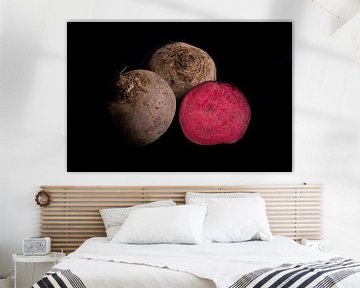 Three red beets on black background by Iris Koopmans