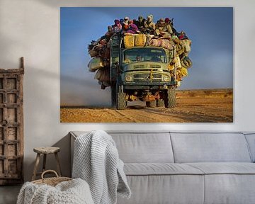 Vrachtwagen met mensen in Sahara woestijn van Frans Lemmens