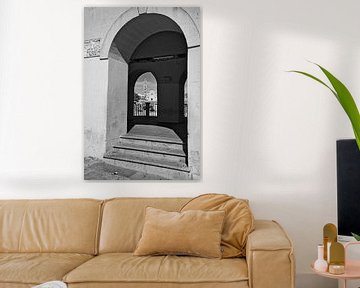 View through a double see through arch in Matera in black and white by iPics Photography