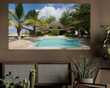 Swimming pool with palm trees and bamboo hut on tropical island by Robin Jongerden