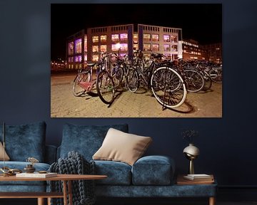 Cycling in front of the concert hall in Amsterdam Netherlands at night by Eye on You