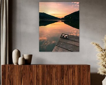 Boat jetty on the calm lake by Christian Klös