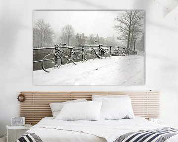 Cycling on the canal in snowy Amsterdam by Eye on You