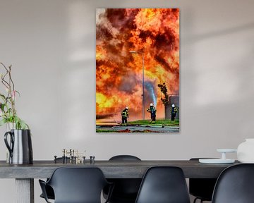 Fire fighters in front of a fire in an industrial area by Sjoerd van der Wal
