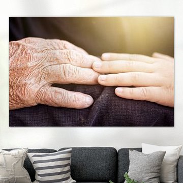 Young hand touches older hand