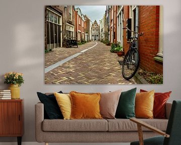 narrow street with bicycle by george vogelaar