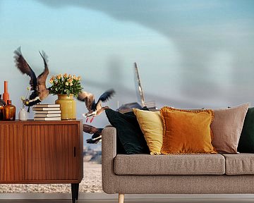 Canadian geese fly up at windmill in winter by Frans Lemmens