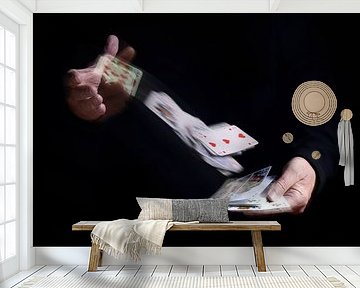 two hands shuffle falling cards with motion blur against a black background, business metaphor or co