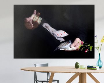 two hands shuffle falling cards with motion blur against a black background, business metaphor or co by Maren Winter