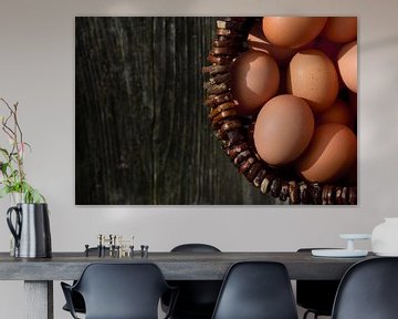 Eggs in basket in front of dark wood by Ulrike Leone