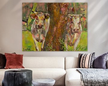 Two cows behind the tree