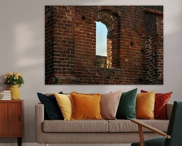 empty window with a tuft of grass in a brick wall of the monastery ruin in Bad Doberan, northern Ger by Maren Winter