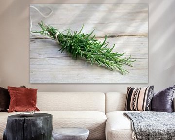 bunch of rosemary herb, Rosmarinus officinalis, on a rustic wooden table, copy space, closeup with s by Maren Winter