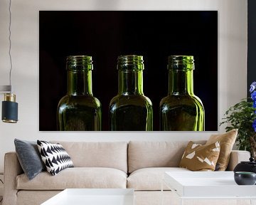 three empty green glass bottles by Ulrike Leone