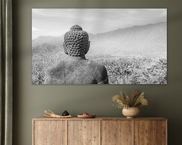 Buddha statue looks over the valley Borobudur Indonesia black and white by John Stijnman