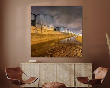 Large silos reflected in a water pond by Tony Vingerhoets