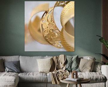 gold colored ornate bracelet in a white environment by Tony Vingerhoets