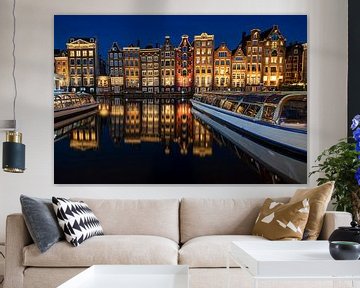Amsterdam houses on the Damrak at night by Eye on You