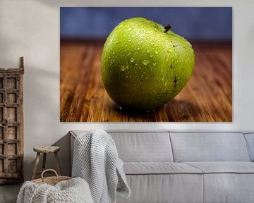 Apple on wooden board by Bernd Hartner