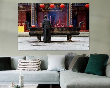 Praying woman in a Buddhist monastery