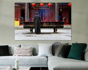 Praying woman in a Buddhist monastery by Henny Hagenaars