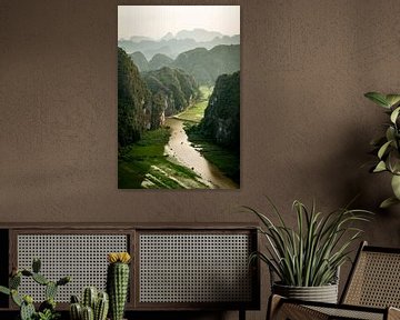 Viewpoint in Tam Coc Vietnam with a hilly landscape and boats in the water. by Twan Bankers