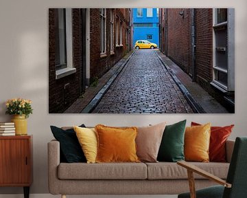 Yellow car against blue wall by Idema Media