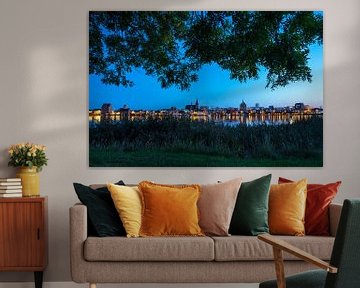 View over the Warnow river to the Hanseatic City of Rostock at the Blue Hour by Rico Ködder