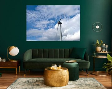 Wind turbine producing electricity in a windpark with clouds in the background