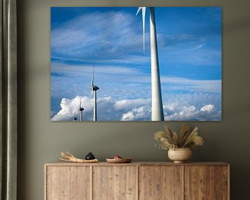 Wind turbine producing electricity in a windpark with clouds in the background by Sjoerd van der Wal