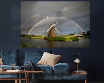 big double rainbow over Dutch windmill in summer rain