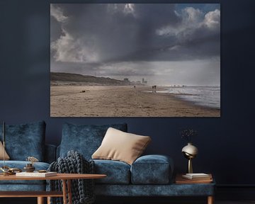 On the beach with dark rain clouds by Anges van der Logt